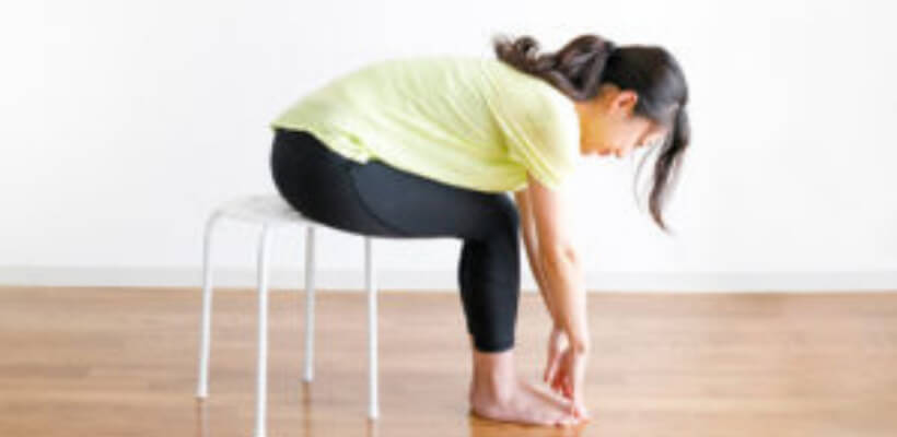 employee practicing desk yoga