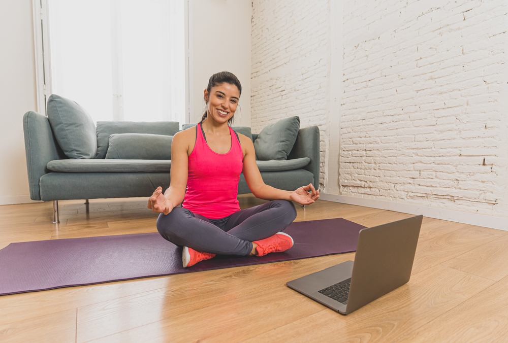 Lady doing yoga through online class