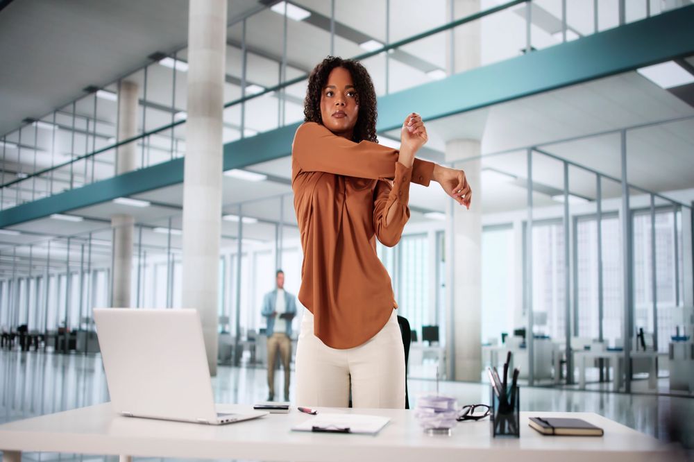 Woman stretching arms at work