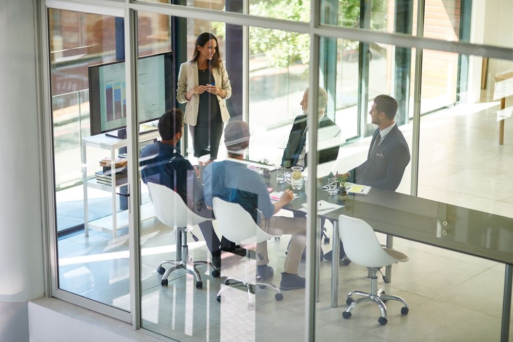 Coworkers chatting in presentation room
